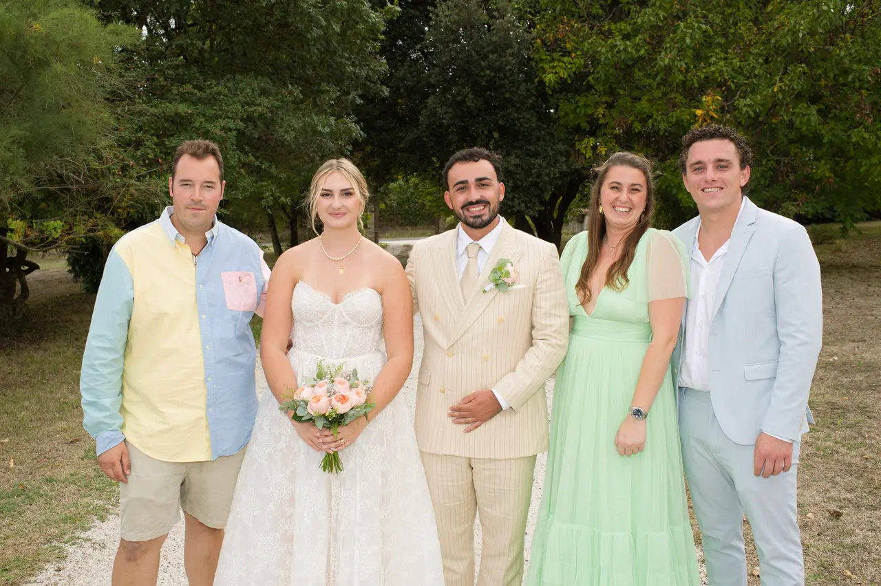 les mariés avec une femme en robe vert menthe, chemise bicolore jaune et bleue, costume bleu ciel